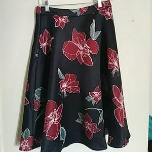 Knee length black skirt with red flower pattern